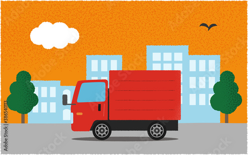 夕方、都市の道路を進む赤いトラックのベクターイラスト