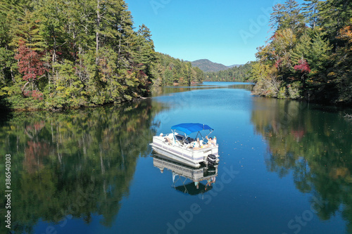 Aerial view of pontoon boat on Lake Santeetlah, North Carolina in autumn.