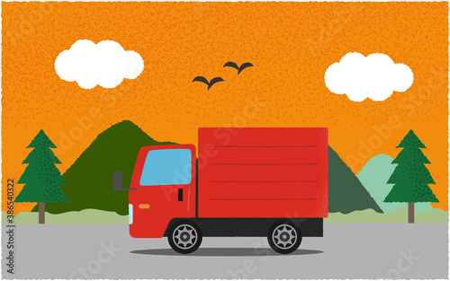 夕方、山沿いの道を進む赤いトラックのベクターイラスト