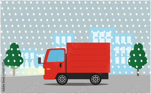 吹雪の中、ライトを点けて都市の道路を進む赤いトラックのベクターイラスト