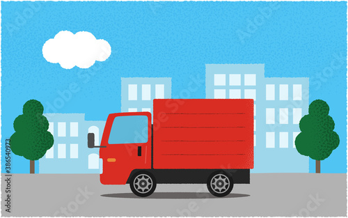 都市の道路を進む赤いトラックのベクターイラスト