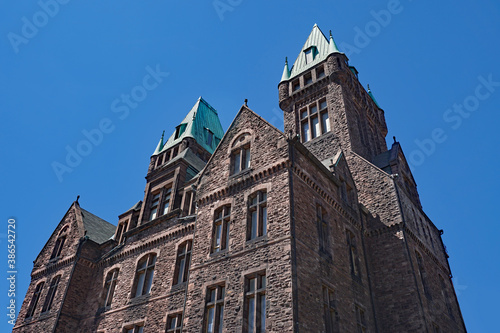Принти на полотні A Gothic style 19th century stone building with copper roof, formerly a mental