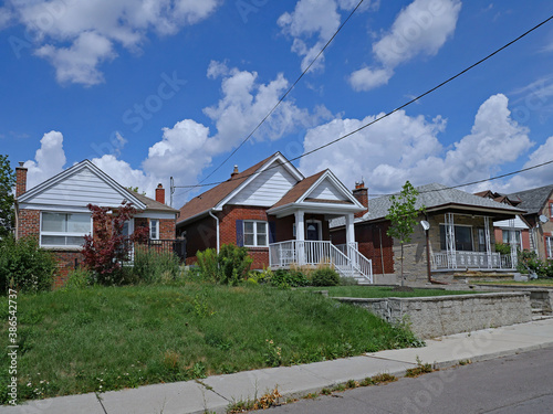 Fototapeta Naklejka Na Ścianę i Meble -  Street with row of modest 1940s style working class bungalows