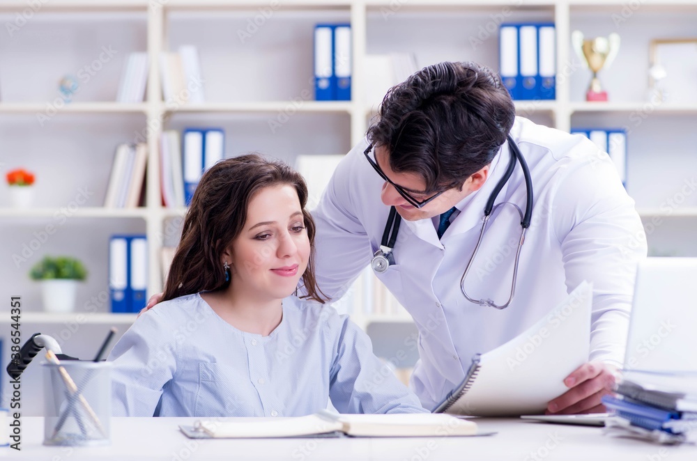 Fototapeta premium Female patient visiting male doctor for regular check-up in hosp