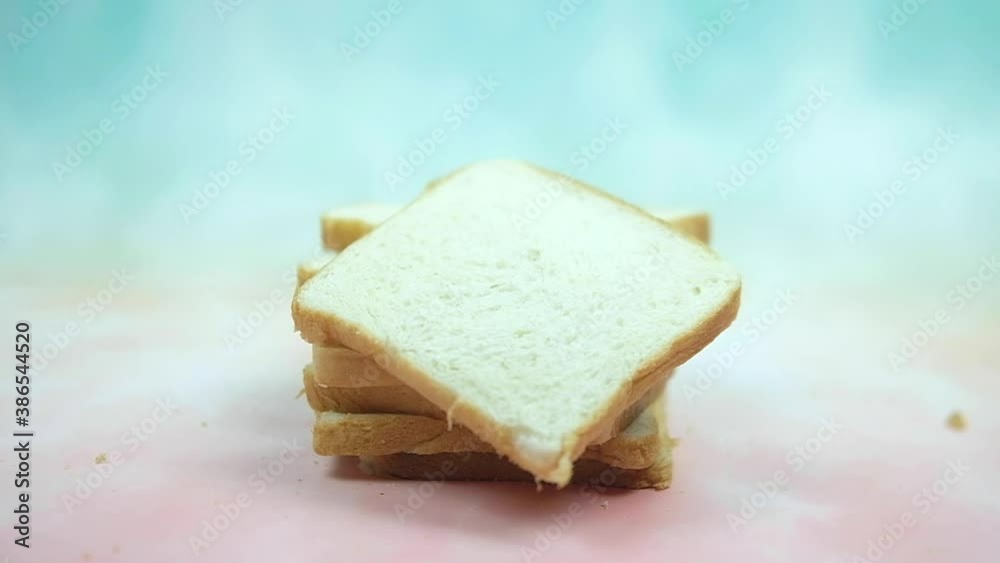 Slices of white bread falling on stock sliced bread. Shot of slow motion Slices of white bread falling on stock sliced bread. Shot of slow motion