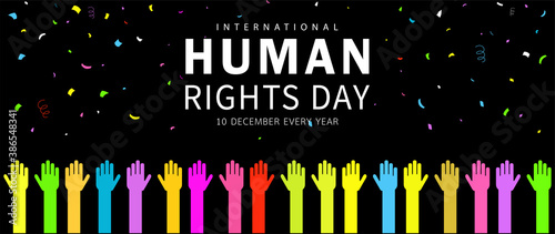 Human Rights Day. International peace. Various colored hand icons raising their hands with colorful ribbon confetti on black background. Cartoon flat design. Vector illustration.