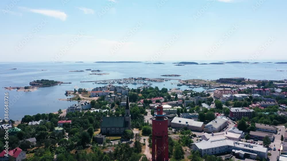 Aerial view overlooking the downtown the church and the water tower, the East harbor in the background, bright, summer day in Hanko, Uusimaa, Finland - dolly, drone shot Aerial view overlooking the downtown the church and the water tower, the East harbor in the background, bright, summer day in Hanko, Uusimaa, Finland - dolly, drone shot