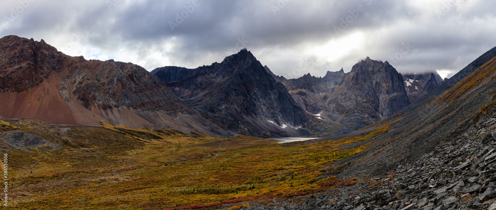 Plakat Beautiful Panoramic View of Dramatic Mountains and Scenic Alpine Lake during Fall in Canadian Nature. Aerial Shot. Taken in Tombstone Territorial Park, Yukon, Canada.