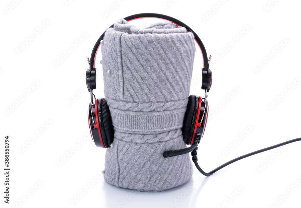 Gray knit sweater with red headphones on white background Gray knit sweater with red headphones on white background