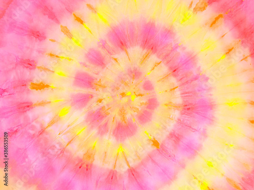 Spiral tie dye wallpaper. Hippie tie-dye background. Tiedye backdrop. Psychedelic tie dye pattern in yellow and pink.