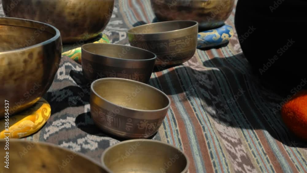 Asian guy playing Tibedt singing copper cups on a viewing mountain Asian guy playing Tibedt singing copper cups on a viewing mountain