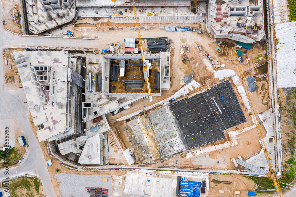 concrete slab foundation building. early stages of construction. construction machinery working at construction site. aerial photography with drone