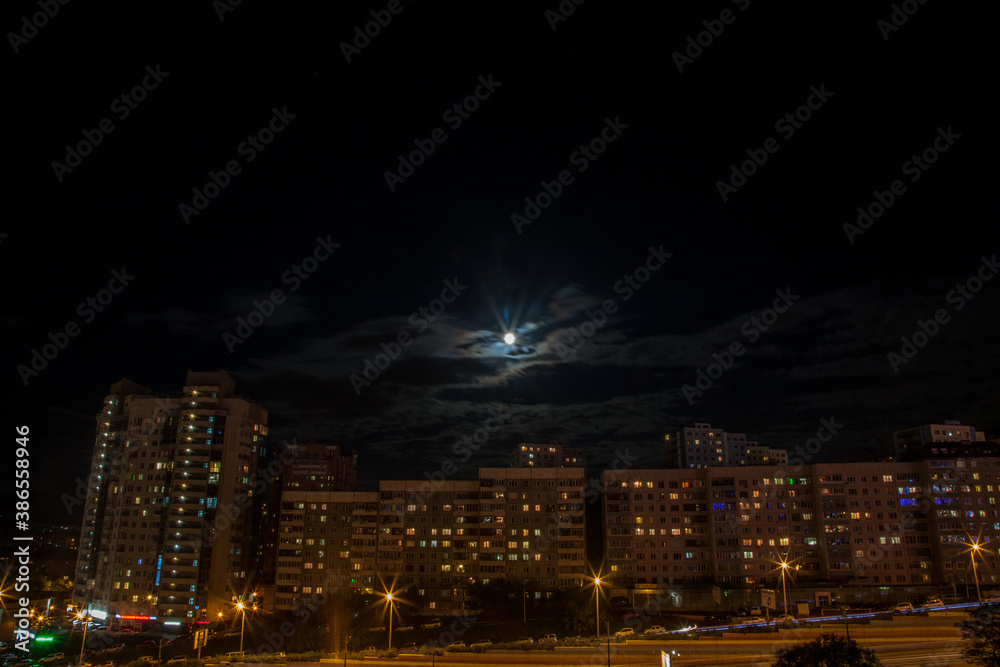 Night view on the buildings of Vladivostok with a full moon shining above 