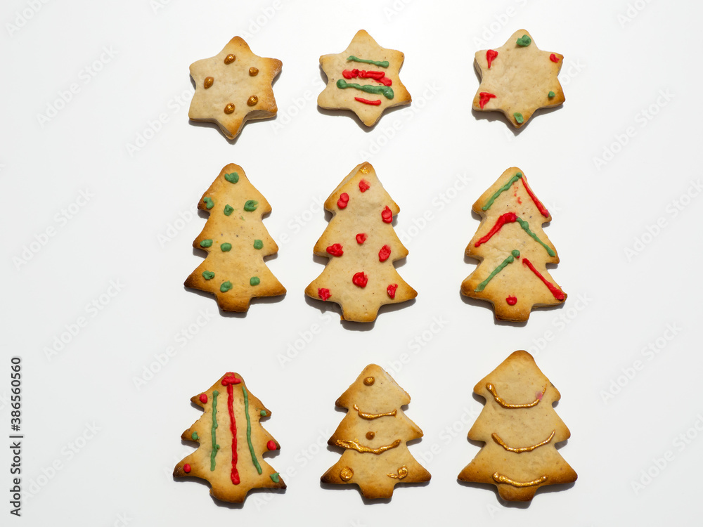 Homemade Christmas gingerbread cookies isolated on white background. Pine and star shaped cookies. Decorated Christmas cookies