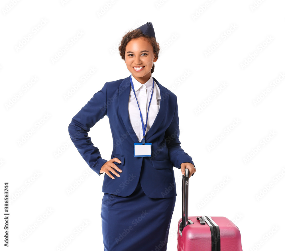 Beautiful African-American stewardess with luggage on white background Beautiful African-American stewardess with luggage on white background