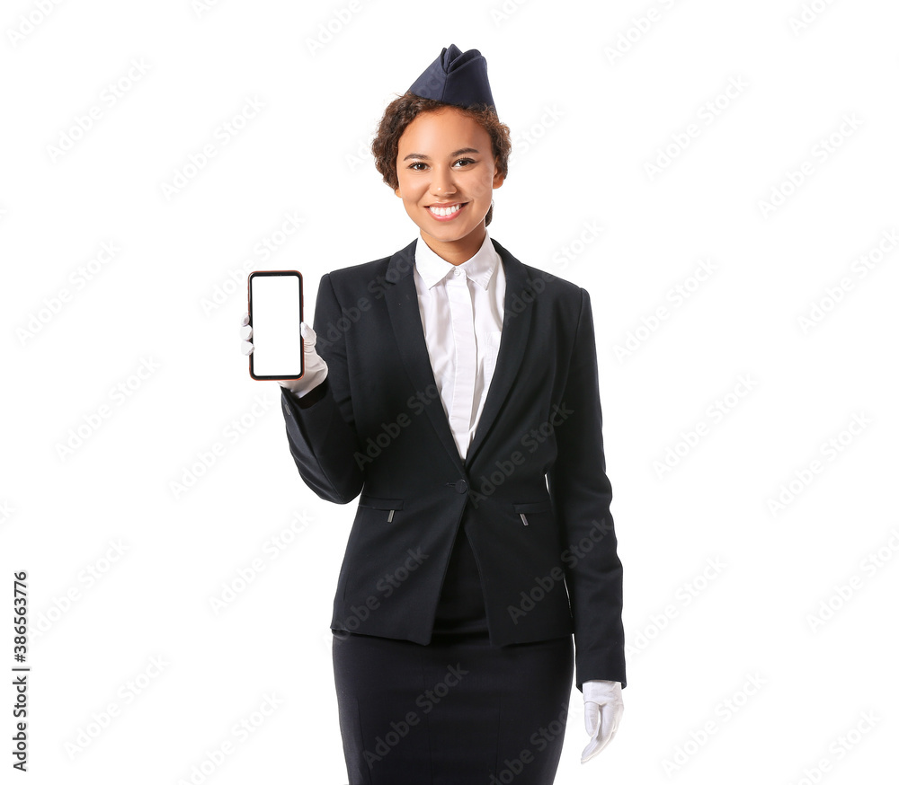 Beautiful African-American stewardess with mobile phone on white background Beautiful African-American stewardess with mobile phone on white background