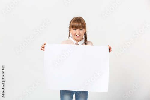 Little girl with blank pape...