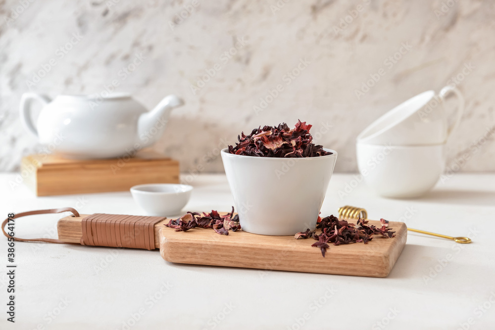 Bowl with dry hibiscus tea on table Bowl with dry hibiscus tea on table