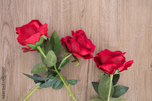 Three red roses on the table