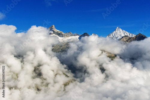 Beautiful Swiss Alps landscape with mountain in clouds view in summer, Zermatt, Switzerland  © Iuliia Sokolovska