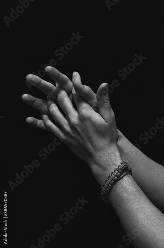 men's hands close up on a black background