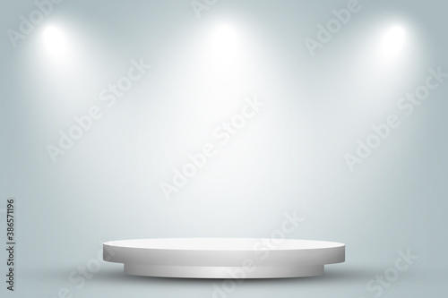 Empty space of Round white podium or pedestal in studio room with spotlight in gray background.