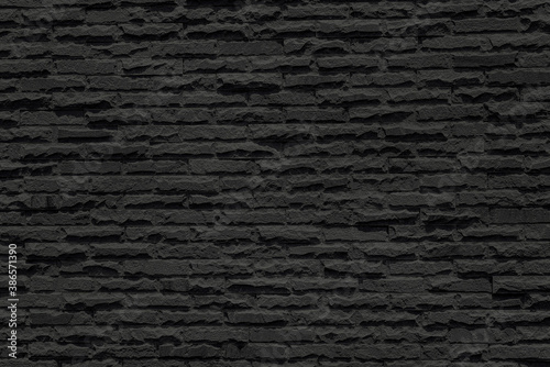 Abstract black brick wall grunge texture background for interior decoration.