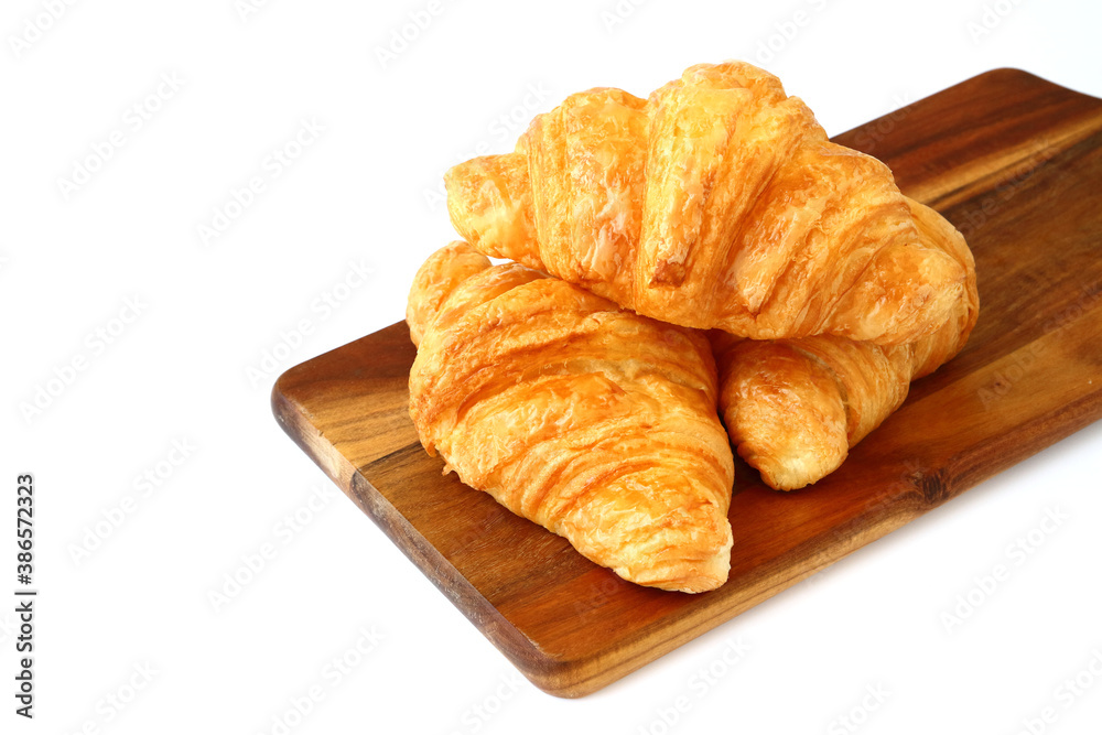 homemade croissants on wooden cutting board isolated on white background homemade croissants on wooden cutting board isolated on white background