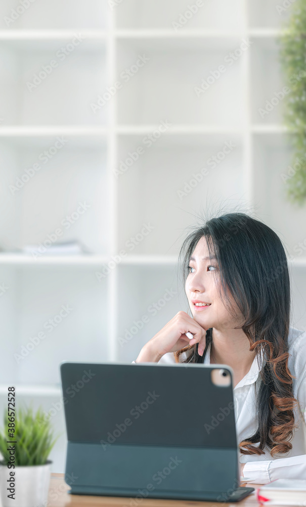 Portrait of young beautiful businesswoman thinking about job while sitting at office desk. Portrait of young beautiful businesswoman thinking about job while sitting at office desk.