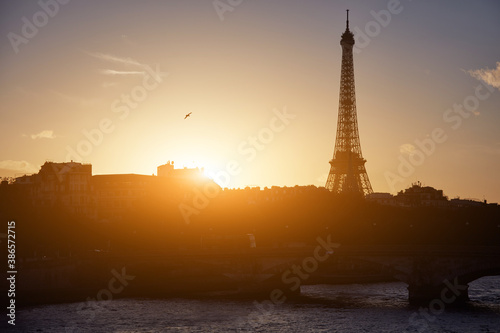Cityscape of Paris, France and famous landmark Eiffel tower in silhouette just before sunset.