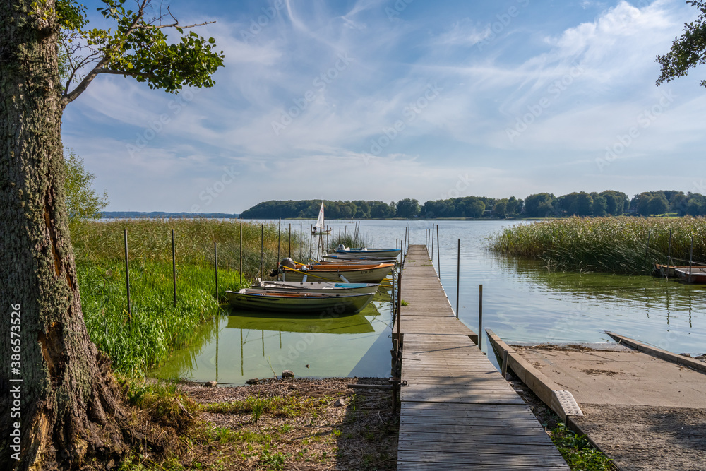 Fototapeta premium A floating jetty and boats in a lake. Picture from Ringsjon, Scania county, Sweden