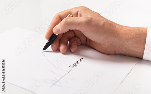 closeup of businessman hand signing contract, signature close up photo