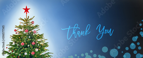 English Text Thank You. Christmas Tree With Christmas Ball Decoration And Ornamen Like Star. Blue Background WIth Bokeh Effect.