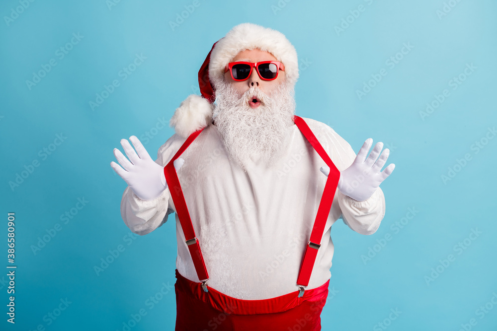 Portrait of his he nice attractive cheery funky playful humorous white-haired Santa pulling suspenders having fun fooling isolated over bright vivid shine vibrant blue color background - obrazy, fototapety, plakaty 