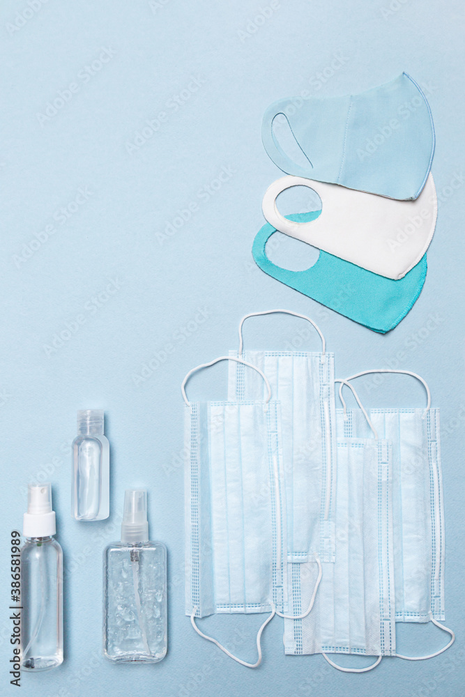 Medical face masks, antiseptic, reusable protective face masks on a blue background copy space. Health care concept Medical face masks, antiseptic, reusable protective face masks on a blue background copy space. Health care concept
