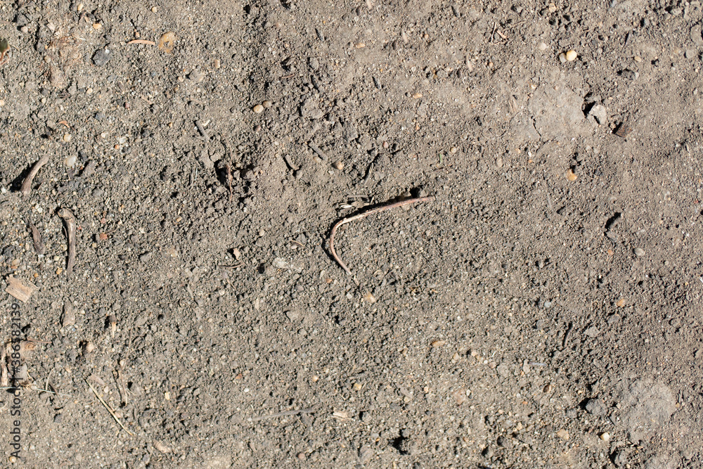 Brown dry stony ground surface. Close up natural background Brown dry stony ground surface. Close up natural background