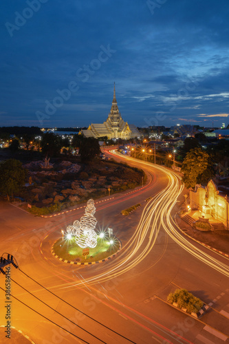 Aerial view of Wat Sothon Wararam or Temple of Dignity, Mueang Cha Choeng Sao District at night with Chao Phraya River, Cha Choeng Sao urban city downtown skyline, near Bangkok, Thailand photo