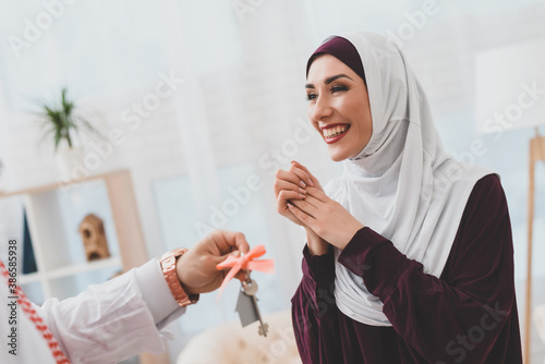 Joyful arab woman rejoices at a gift from a man. photo