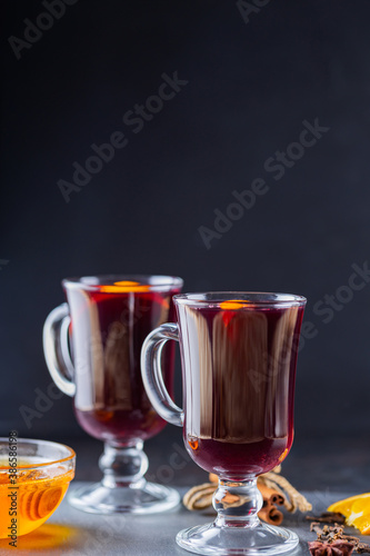 Mulled wine on a slate board. Two glasses of hot mulled wine and ingredients. Christmas hot drink with wine and honey