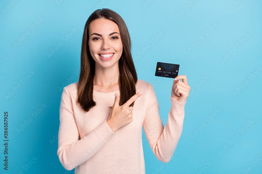 Close-up portrait of her she nice attractive cheerful cheery brown-haired girl holding in hands demonstrating bank card paypass service isolated on bright vivid shine vibrant blue color background Close-up portrait of her she nice attractive cheerful cheery brown-haired girl holding in hands demonstrating bank card paypass service isolated on bright vivid shine vibrant blue color background