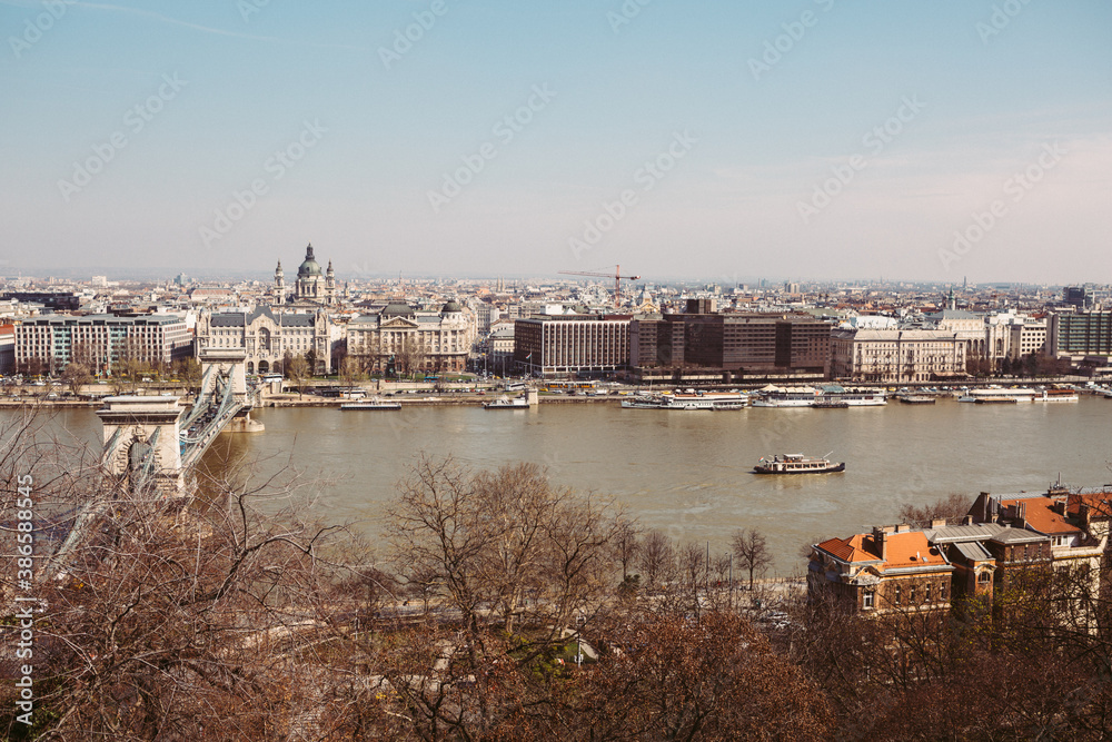 Panoramic view of Budapest, from the Buda part to the Pest, over the Danube river with the sailing sightseeing cruise during the sunny spring day