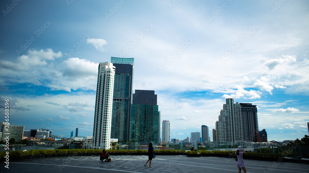 Fototapeta premium Bangkok thailand 14/9/20 Jaopraya river side view, A daytime sky with white clouds in the city, focus on the buildings.