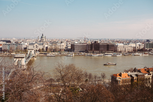 Panoramic view of Budapest, from the Buda part to the Pest, over the Danube river with the sailing sightseeing cruise during the sunny spring day photo