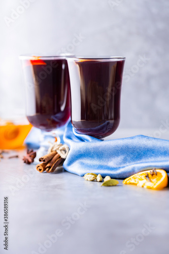 Christmas hot drink. Mulled wine on gray background. Two glasses of autumn mulled wine on a blue napkin. Copy space