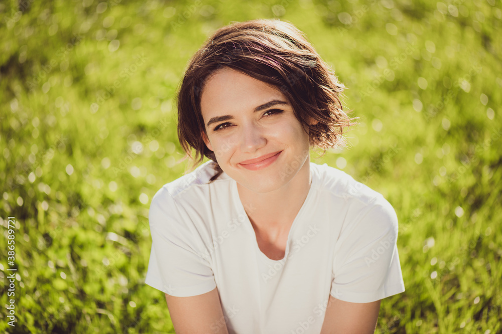 Closeup headshot photo of dreamy lovely charming lady smiling face sitting grass ground comfortable relaxing nice look waiting sun go down meet sunset wear white shirt outdoors Closeup headshot photo of dreamy lovely charming lady smiling face sitting grass ground comfortable relaxing nice look waiting sun go down meet sunset wear white shirt outdoors