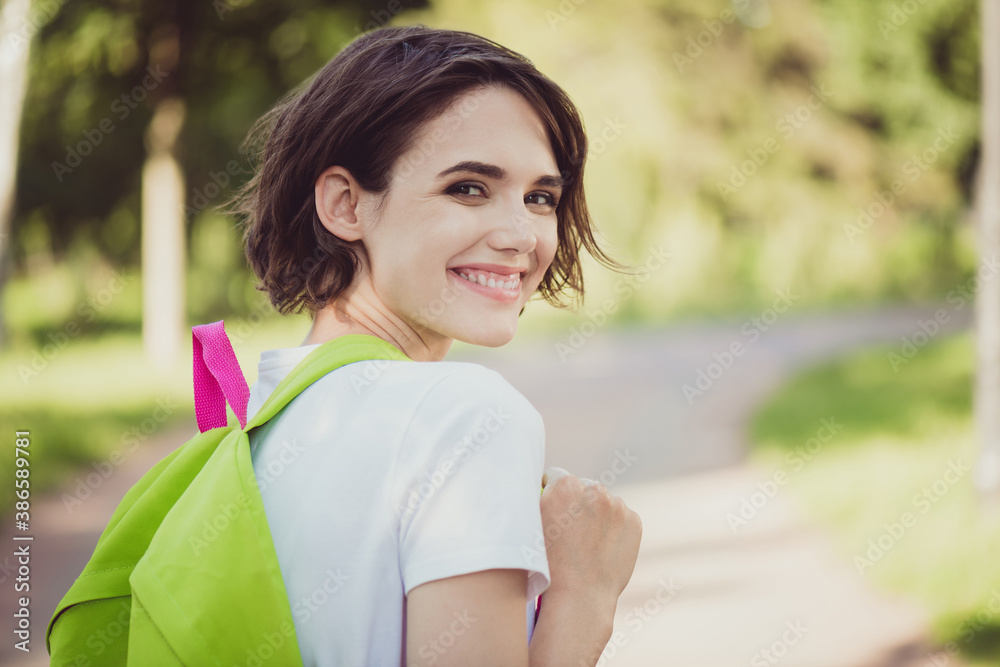 Profile view closeup photo of pretty cute lady school backpack shoulders walk city central park good mood diligent student go classes lessons lectures wear t-shirt green road outdoors