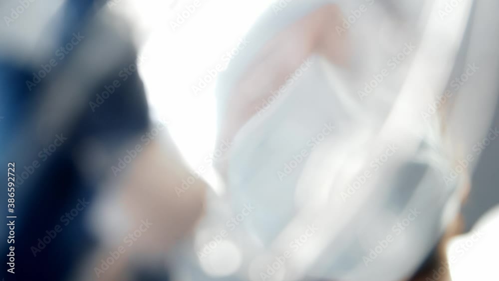 First-person view of the oxygen mask in doctor's hand. Patient looking to the face of the surgeon in protective mask. Anesthesia and narcosis. First-person view of the oxygen mask in doctor's hand. Patient looking to the face of the surgeon in protective mask. Anesthesia and narcosis.