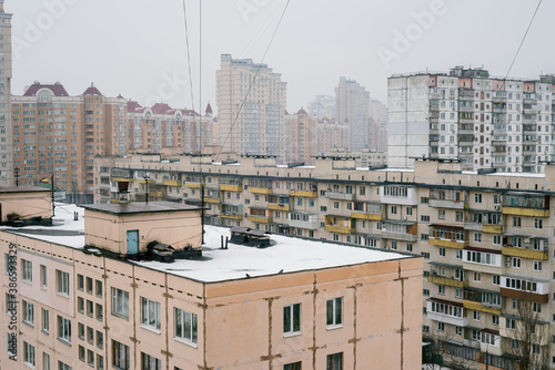 Rooftops and high residential buildings covered by snow in winter in the Obolon district of Kiev, Ukraine