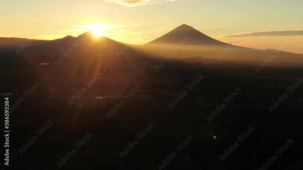Aerial View Of Mount Agung During Sunrise In Bali, Indonesia. Picturesque Mountains Landscape Near Volcano, Wonderful Tropical Nature At Sunset. Aerial View Of Mount Agung During Sunrise In Bali, Indonesia. Picturesque Mountains Landscape Near Volcano, Wonderful Tropical Nature At Sunset.