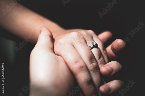 beautiful diamond engagement ring on the finger holding hands